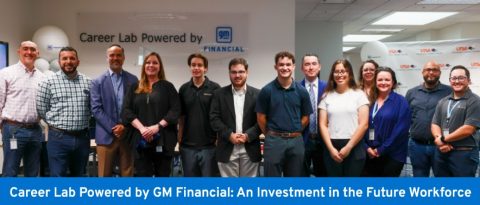 Group photo of thirteen people standing in front of a sign that says “Career Lab Powered By GM Financial.” The words “Career Lab Powered by GM Financial” and “An Investment in the Future Workforce” also appear below the photo of the individuals. 